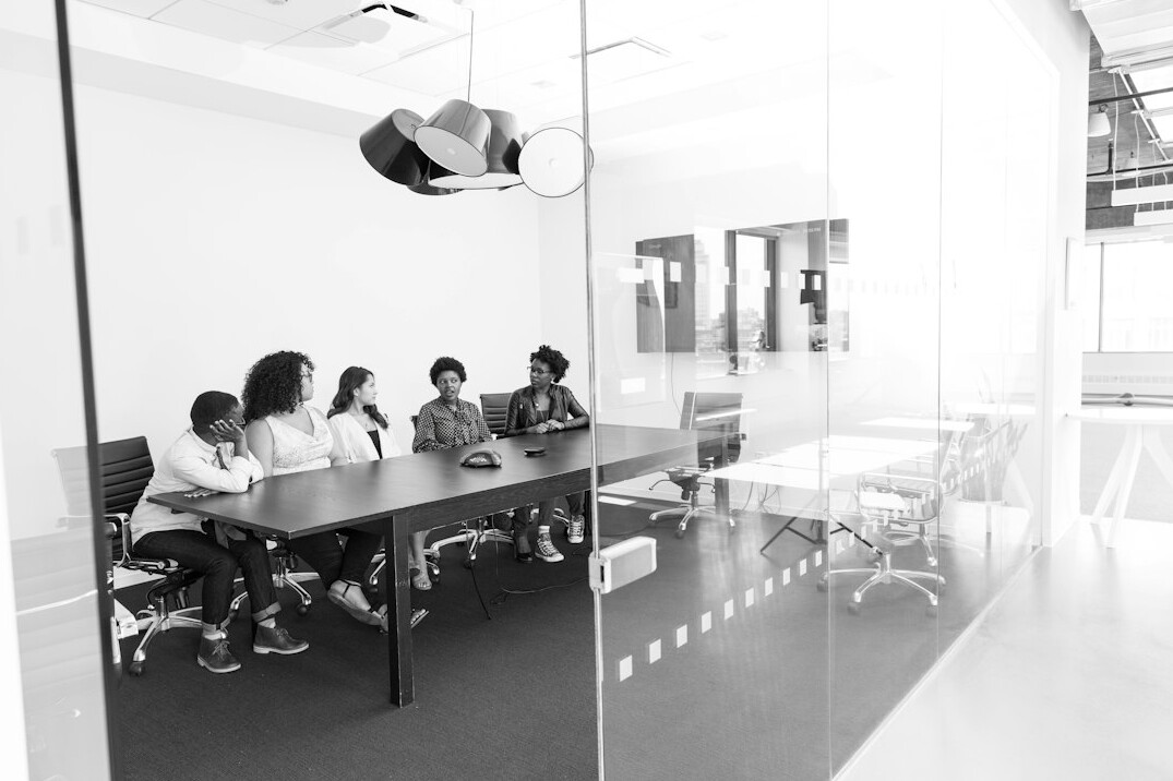 Empty corporate boardroom with chairs around a long table